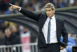Real Madrid coach Manuel Pellegrini points out at his players