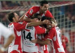 Almeria's players erupt in joy and celebration after scoring a goal during a league game