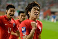 South Korea national football team players celebrating after scoring a goal in the 2010 FIFA World Cup qualifiers in the AFC zone.