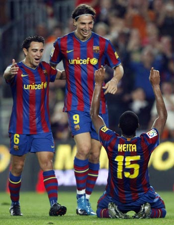 Xavi Hernandez, Zlatan Ibrahimovic, and Seydou Keita celebrating a goal as Barcelona destroyed Real Zaragoza 6-1.