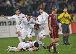 Slovenia celebrate their way through to South Africa 2010 at the final whistle while Russia face anguish after defeat