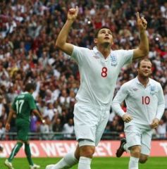 Frank Lampard raises his arms to the sky as he scores for England in a friendly against Slovenia