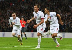 England's captain John Terry erupts in joy and celebration as England finally beat Ukraine to maintain their perfect record. Rooney and Ferdinand run in celebrations as well.