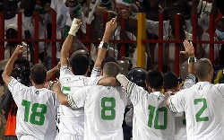 Algeria players celebrate in front of the crowd as they reach South Africa 2010 at last