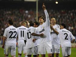Kaka, surrounded by the rest of his Real Madrid teammates, points out to the crowd in celebration