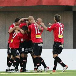 Real Mallorca players celebrate during a La Liga match as the team takes the lead.