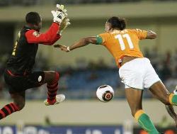 Didier Drogba of the Ivory Coast jumps as he tries to knock the ball past Burkina Faso's goalkeeper