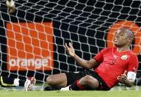 Mozambique's captain falls down to the ground in the goal area.