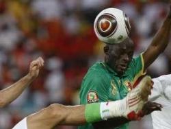One of Mali's players trying to head the ball away as he defends against Algeria