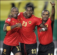 Manucho and Flavio celebrate along side another team mate as Angola score a goal.