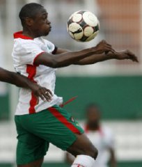 Burkina Faso player controlling the ball on his chest against Ivory Coast.