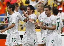 Algerian players celebrating together after scoring against Mali on match-day two.