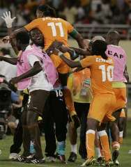 The Ivory Coast' Didier Drogba celebrates with the subs on the bench as he scores goal n.3 against Ghana in a must-win game.