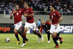 Egypt's players celebrate once again as they widen the gap against Algeria.