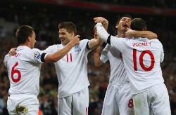 England's John Terry, Steven Gerrard, Frank Lampard, and Wayne Rooney celebrate a 2010 World Cup qualifier goal.