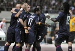 Players of Olympique Lyonnais celebrating a goal together.