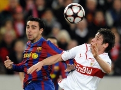 Xavi Hernandez and a Stuttgart player in the Champions League