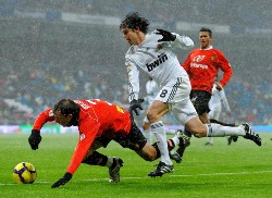 Real Madrid's Kaka vying challenged by Real Mallorca players.