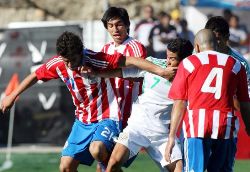 Paraguay players fighting for the ball in a game against Mexico.
