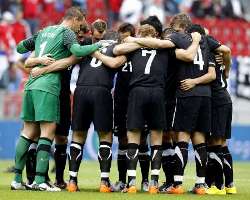 New Zealand players together before kick off against Serbia.