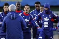 France players listening to Coach Raymond Domenech during training.