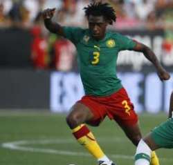 Cameroon defender trying to bypass a Portuguese player during a friendly match.
