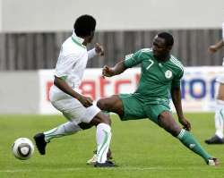 Nigerian player tackling a player from Saudi Arabia.