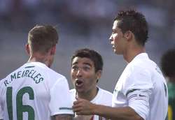 Raul Meireles, Deco, and Cristiano Ronaldo communicating during Portugal's friendly match against Cameroon.