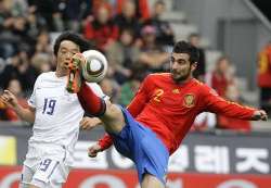 Spain's Raul Albiol defends against South Korea.