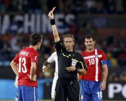 Serbia's number 13 shown the red card in a 2010 World Cup match against Ghana. Dejan Stankovic is pictured in the background.