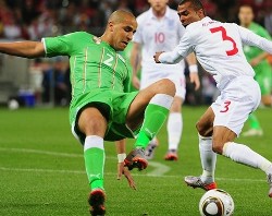 Algeria's Majid Bougherra vies against England's Ashley Cole.