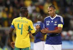South Africa's Aaron Mokoena hand shakes France's Thierry Henri as the respective side of the two captains crash out from the 2010 FIFA World Cup.