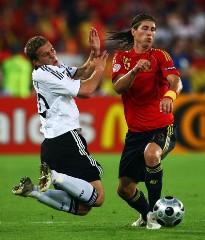 Euro 2008: Germany's Lucas Podolski falls on the ground as Spain's Sergio Ramos tackles him.
