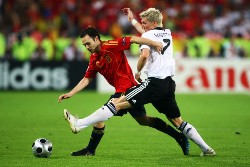 Germany's Bastian Schweinsteiger pictured while trying to tackle Spain's Andres Iniesta during the final of Euro 2008.