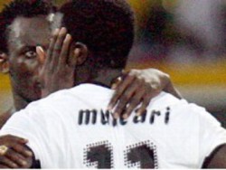 Ghana's Michael Essien comforts teammate Sulley Muntari