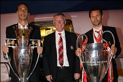 Manchester United manager Alex Ferguson (middle), Rio Ferdinand (left), Ryan Giggs (right) exhibiting the double they won in 2008.