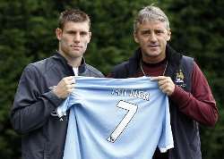 New Manchester City player James Milner pictured with Coach Roberto Mancini during his presentation at the club.