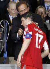 Bayern Munich Captain Van Bommel accepts his losers medal near the 2009/2010 UEFA Champions League trophy.