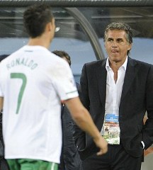 Portugal's Cristiano Ronaldo walks off the pitch as Coach Carlos Queiroz watches.