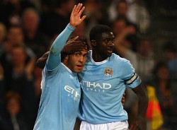 English Premier League: Manchester City's Kolo Toure congratulates goal scorer Carlos Tevez