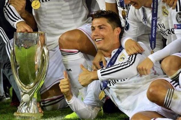 Ronaldo posing with the UEFA Super Cup and his medal.