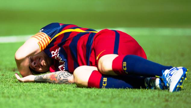 Leonel Messi injured in action for Barcelona 