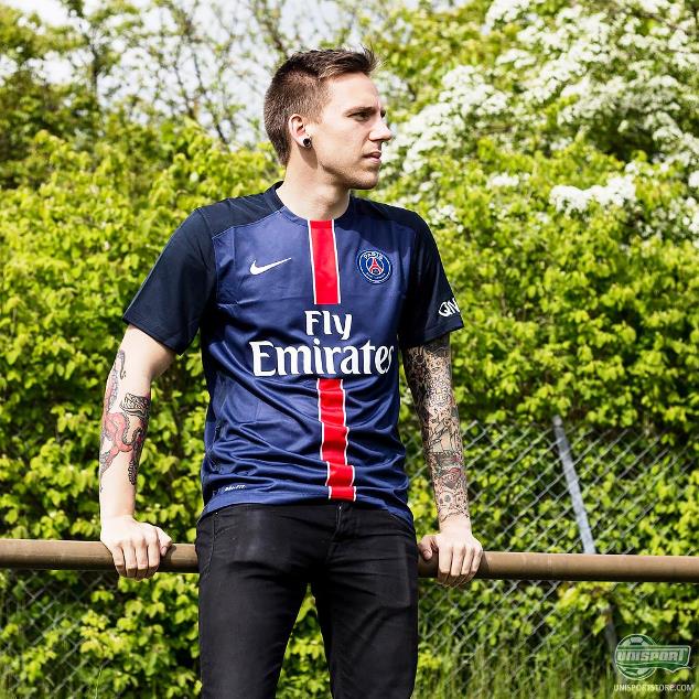 A PSG fan posses in his team's home jersey