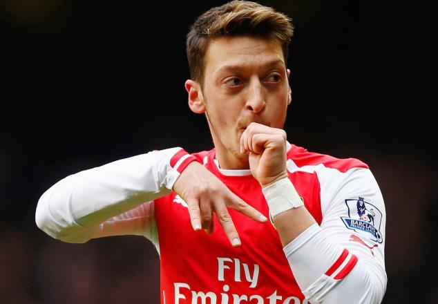 Ozil celebrates one of his goals for Arsenal