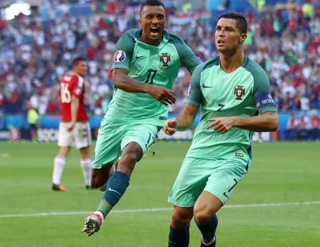Portugal's Cristiano Ronaldo (right) celebrates scoring against Hungary in their last match of Group F
