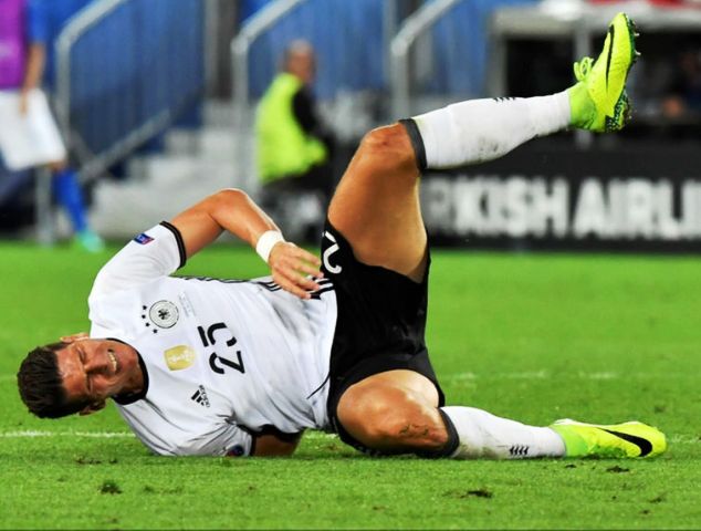 Mario Gomez writhes in pain after picking up an injury during the Germany vs Italy Euro 2016 game