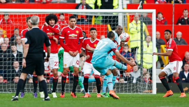 The West Ham United sensation curls the ball behind a wall of Man United players last season during their FA Cup semi-final clash
