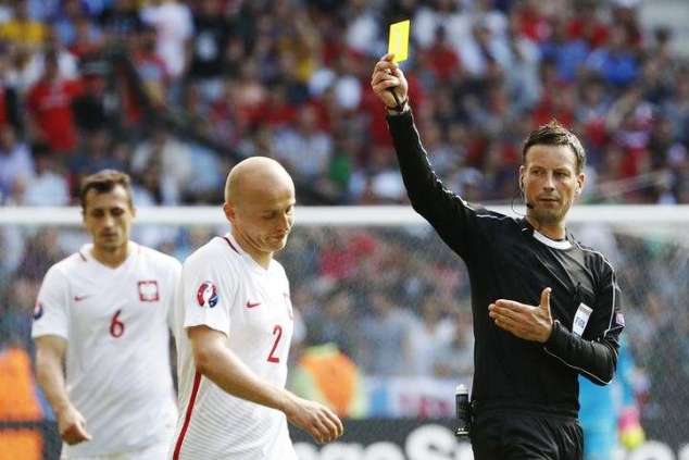 Defender Michal Padzan receives a yellow card from Clattenberg 