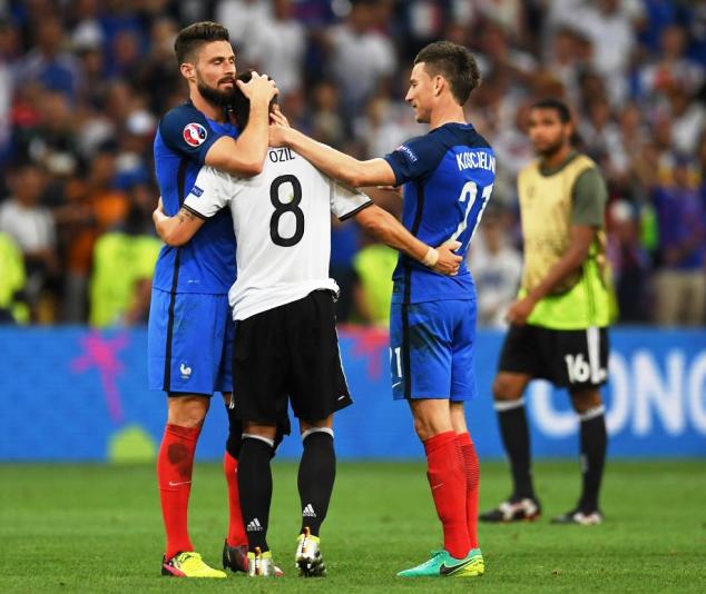 Olivier Giroud (far left) and Laurent Koscielny (right) console Mesut Ozil after Germany lost to France on Thursday in the semi-finals of the Euro 2016
