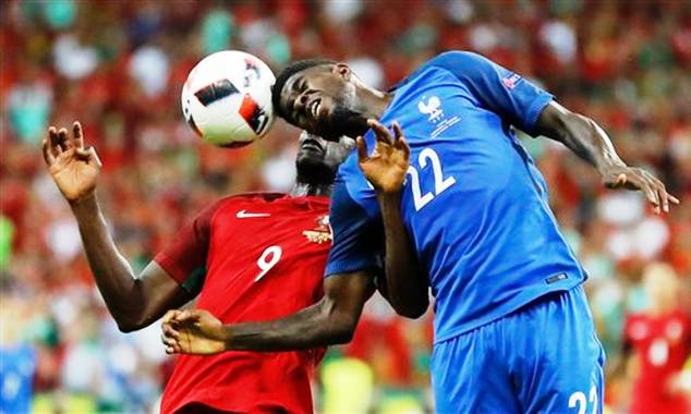 The French central defender fight for the ball with Portugal striker Eder during the finals of the European Championship